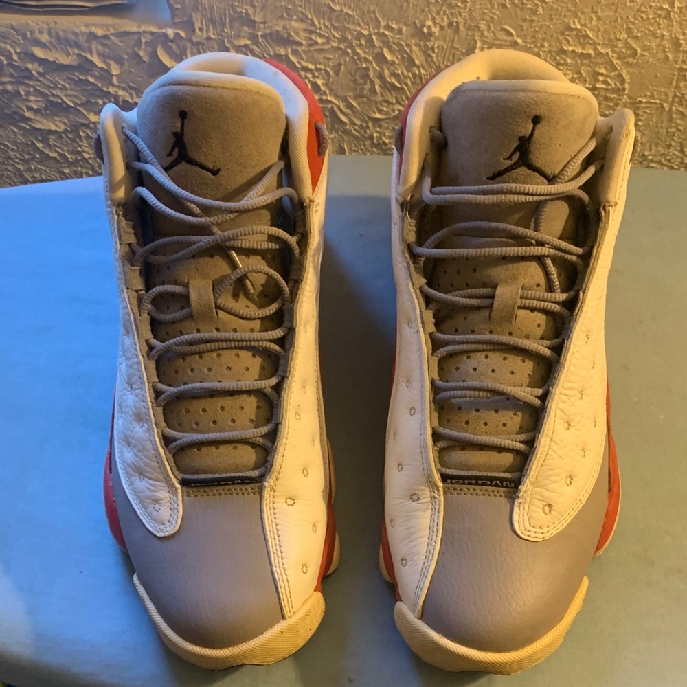 Jordan 13 men’s grey, red and white athletic shoes.